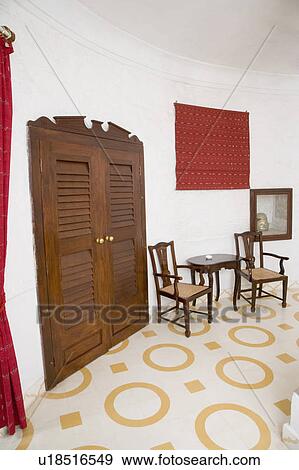 Stock Photo - Empty chairs and a table in a hotel room. Fotosearch