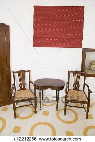 Stock Photograph - Empty chairs and tables in a hotel room. Fotosearch
