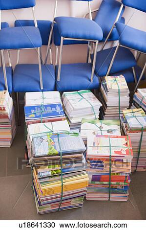 High angle view of stacks of books beside chairs View Large Photo Image Stock Image - High angle view of stacks of books beside chairs. Fotosearch