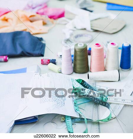 Stock Image - Spools of thread with a tape measure. Fotosearch