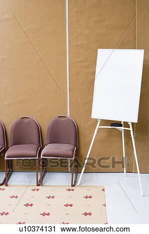 Stock Image - Whiteboard and chairs in a conference room. Fotosearch