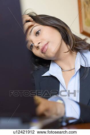 Stock Image - Close-up of a businesswoman working on a laptop. Fotosearch