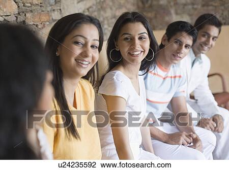 Close-up of a group of people sitting together View Large Photo Image Stock Image - Close-up of a group of people sitting together. Fotosearch