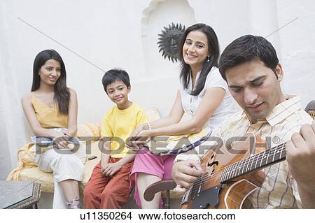 Close-up of a young man playing a guitar View Large Photo Image Picture - Close-up of a young man playing a guitar. Fotosearch
