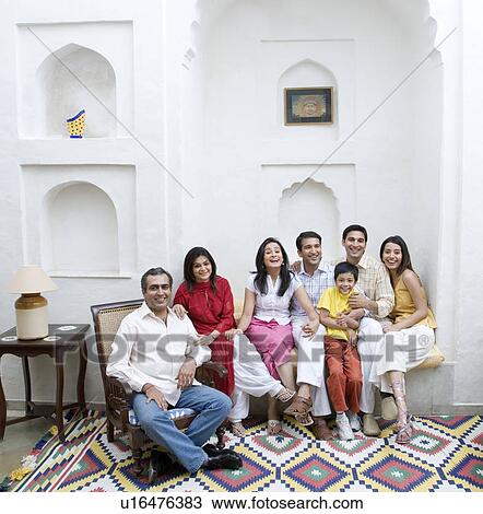 Family sitting in a room and smiling View Large Photo Image Stock Image - Family sitting in a room and smiling. Fotosearch