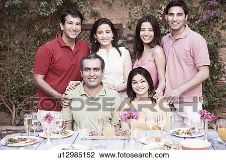 Portrait of a group of people at a dining table and smiling View Large Photo Image Stock Image - Portrait of a group of people at a dining table and smiling. Fotosearch