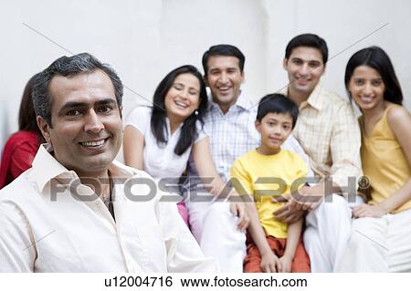 Portrait of a group of people sitting together and smiling View Large Photo Image Stock Photograph - Portrait of a group of people sitting together and smiling. Fotosearch