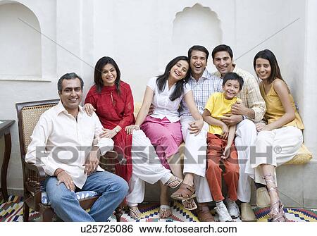 Stock Photograph - Portrait of a group of people sitting together and smiling. Fotosearch