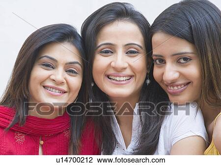 Stock Image - Portrait of three friends smiling together. Fotosearch