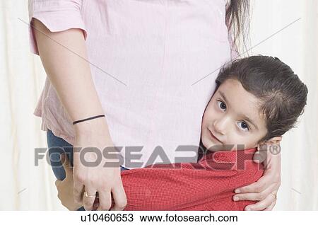 Stock Image - Mid section view of a woman with her son. Fotosearch