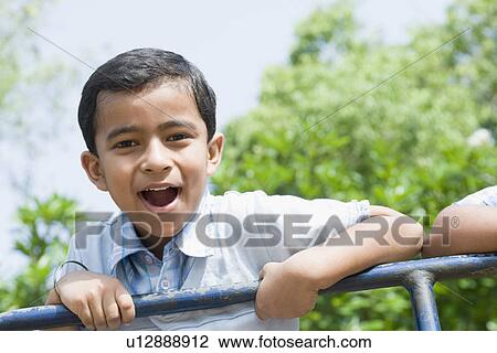Portrait of a boy looking cheerful View Large Photo Image Stock Image - Portrait of a boy looking cheerful. Fotosearch