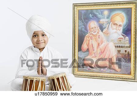 Portrait of a boy sitting in front of bongo and praying View Large Photo Image Stock Photo - Portrait of a boy sitting in front of bongo and praying . Fotosearch