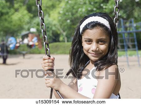 Portrait of a girl on a swing View Large Photo Image Picture - Portrait of a girl on a swing. Fotosearch
