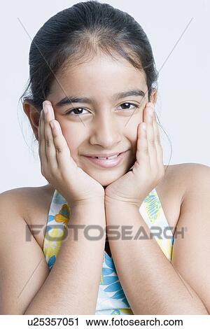 Portrait of a girl smiling with her head in her hands View Large Photo Image Stock Image - Portrait of a girl smiling with her head in her hands. Fotosearch