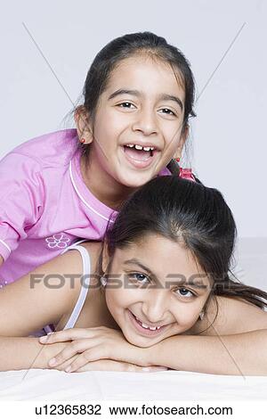 Portrait of two girls smiling View Large Photo Image Stock Image - Portrait of two girls smiling. Fotosearch