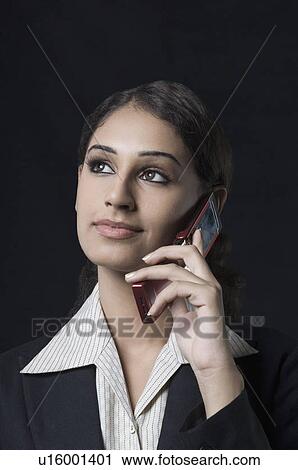 Close-up of a businesswoman talking on a mobile phone View Large Photo Image Stock Image - Close-up of a businesswoman talking on a mobile phone. Fotosearch