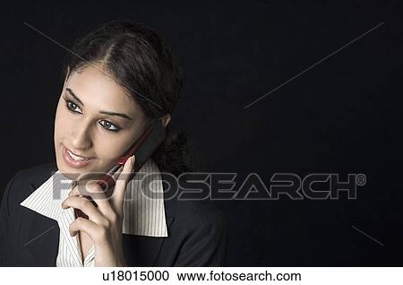 Close-up of a businesswoman talking on a mobile phone View Large Photo Image Stock Image - Close-up of a businesswoman talking on a mobile phone. Fotosearch