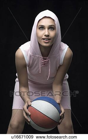 Close-up of a young woman holding a volleyball and smiling View Large Photo Image Stock Photo - Close-up of a young woman holding a volleyball and smiling. Fotosearch