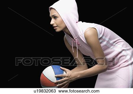 Side profile of a young woman holding a volleyball View Large Photo Image Stock Image - Side profile of a young woman holding a volleyball. Fotosearch