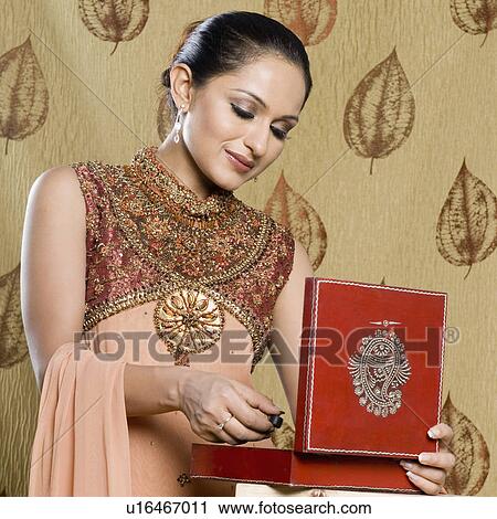 Stock Image - Close-up of a mid adult woman in salwar kameez and holding a jewelry box. Fotosearch