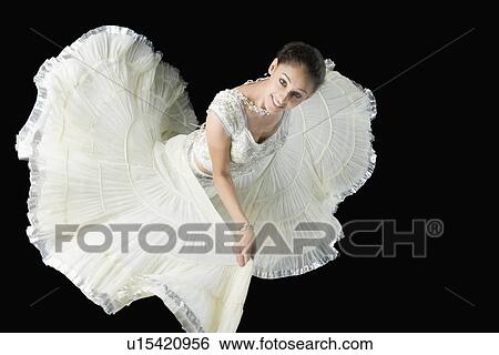 Stock Photograph - High angle view of a young woman dancing in lehenga choli. Fotosearch