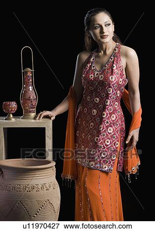 Mid adult woman standing in salwar kameez View Large Photo Image Stock Photo - Mid adult woman standing in salwar kameez. Fotosearch