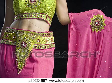 Mid section view of a mid adult woman standing in lehenga choli View Large Photo Image Stock Photo - Mid section view of a mid adult woman standing in lehenga choli. Fotosearch
