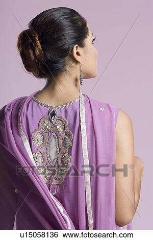 Rear view of a mid adult woman standing in salwar kameez View Large Photo Image Stock Photograph - Rear view of a mid adult woman standing in salwar kameez. Fotosearch