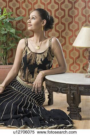 Young woman in lehenga choli and sitting on the floor View Large Photo Image Stock Photography - Young woman in lehenga choli and sitting on the floor. Fotosearch