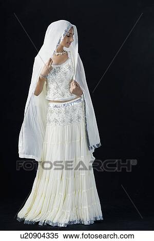 Stock Photography - Young woman in lehenga choli with her eyes closed. Fotosearch