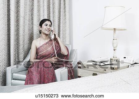 Young woman talking on the telephone View Large Photo Image Stock Image - Young woman talking on the telephone. Fotosearch
