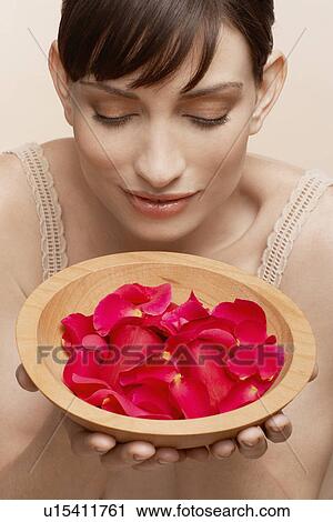 Mid adult woman holding bowl of petals View Large Photo Image Stock Image - Mid adult woman holding bowl of petals. Fotosearch
