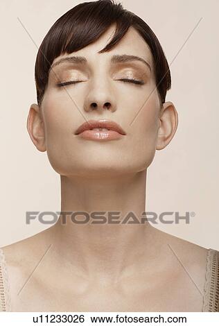 Mid adult woman with eyes closed View Large Photo Image Stock Photograph - Mid adult woman with eyes closed. Fotosearch