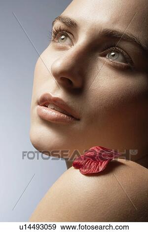 Single petal on woman's bare shoulder View Large Photo Image Stock Photo - Single petal on woman's bare shoulder. Fotosearch