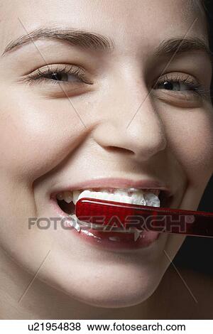 Woman brushing teeth, close-up View Large Photo Image Stock Photo - Woman brushing teeth, close-up. Fotosearch