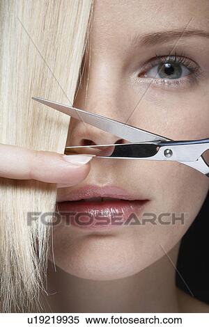 Young woman cutting her hair, close-up View Large Photo Image Stock Photography - Young woman cutting her hair, close-up. Fotosearch
