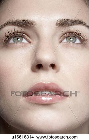 Young woman looking up, close-up View Large Photo Image Picture - Young woman looking up, close-up. Fotosearch