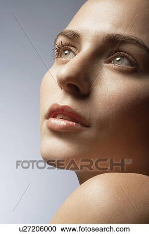 Young woman looking up View Large Photo Image Stock Image - Young woman looking up. Fotosearch