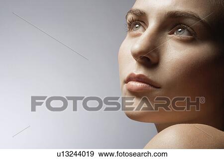 Young woman looking up View Large Photo Image Stock Photo - Young woman looking up. Fotosearch