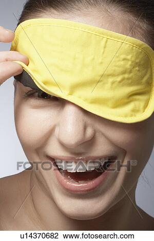 Young woman wearing sleep mask View Large Photo Image Stock Image - Young woman wearing sleep mask. Fotosearch