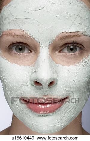 Stock Photo - Young woman with face mask, close-up. Fotosearch