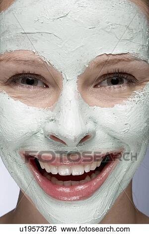 Young woman with face mask, close-up View Large Photo Image Stock Photograph - Young woman with face mask, close-up. Fotosearch