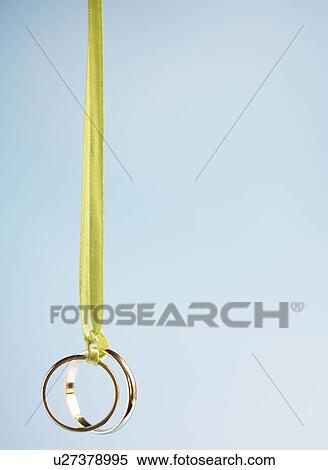 Stock Photography - Two wedding rings on ribbon. Fotosearch