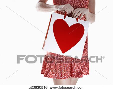 Woman carrying shopping bag (close-up) View Large Photo Image Stock Photograph - Woman carrying shopping bag (close-up). Fotosearch