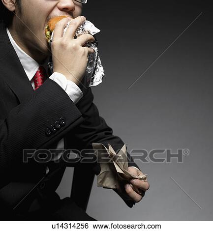 Businessman Eating Hamburger View Large Photo Image Stock Photograph - Businessman Eating Hamburger. Fotosearch