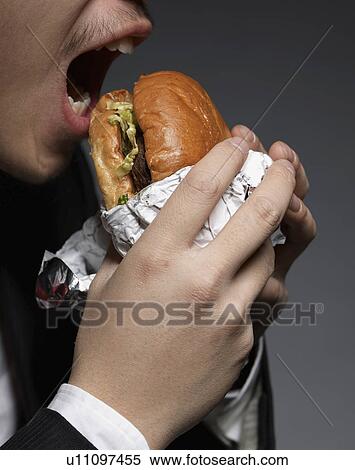 Businessman Eating Hamburger View Large Photo Image Stock Photography - Businessman Eating Hamburger. Fotosearch