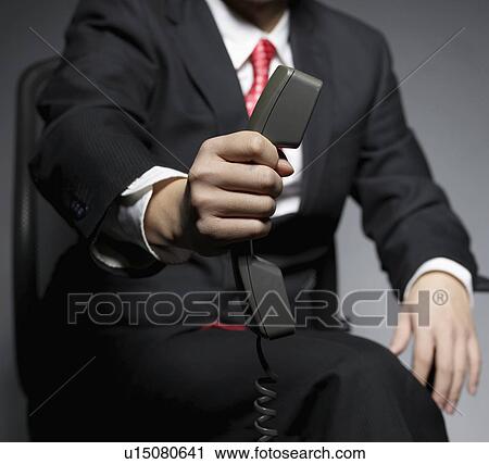 Businessman Holding Telephone Receiver View Large Photo Image Stock Image - Businessman Holding Telephone Receiver. Fotosearch