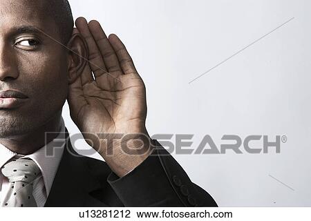 Businessman listening with hand on ear View Large Photo Image Stock Image - Businessman listening with hand on ear. Fotosearch