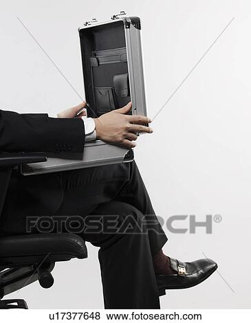 Stock Photo - Businessman Opening Briefcase. Fotosearch