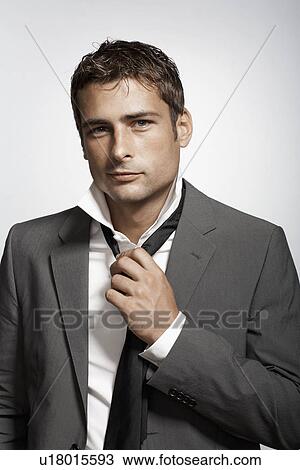 Businessman putting necktie on View Large Photo Image Stock Image - Businessman putting necktie on. Fotosearch